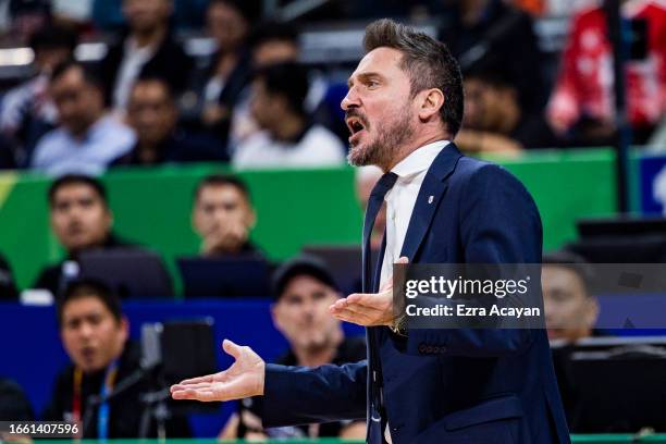 Coach Gianmarco Pozzecco of Italy argues with a referee after Nicolo Melli suffered an injury from Brandon Ingram of the United States during the...