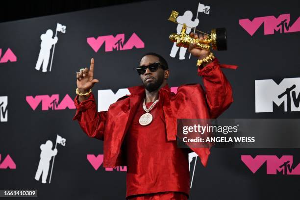 Producer-musician Sean "Diddy" Combs poses with the Global Icon award in the press room during the MTV Video Music Awards at the Prudential Center in...