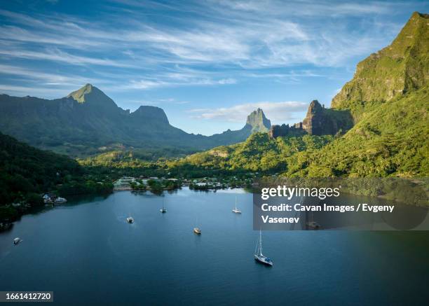 sailing boats near the moorea shore in the morning - french polynesia stock pictures, royalty-free photos & images