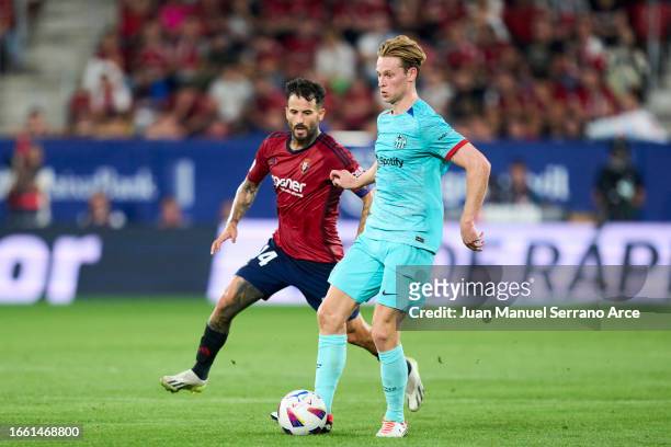 Frenkie De Jong of FC Barcelona duels for the ball with Ruben Garcia of CA Osasuna during the LaLiga EA Sports match between CA Osasuna and FC...