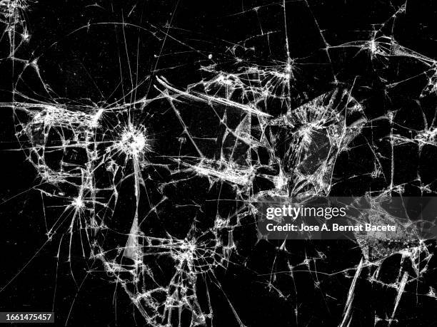 screen of a mobile phone with broken glass. - glass shatter stock pictures, royalty-free photos & images