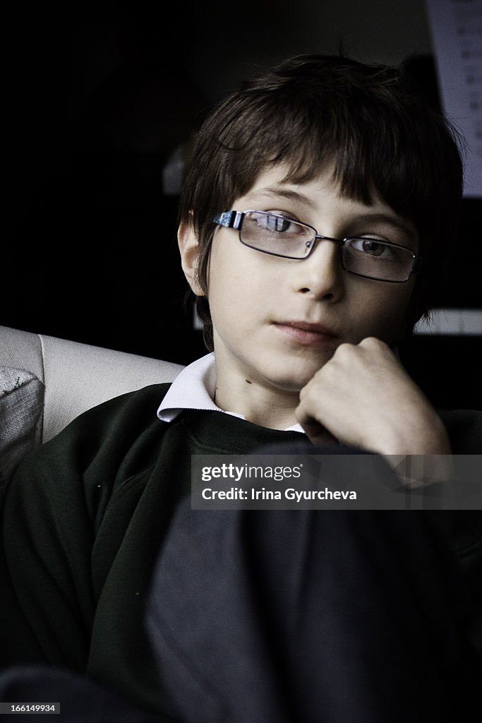 A potrait of a boy with glasses