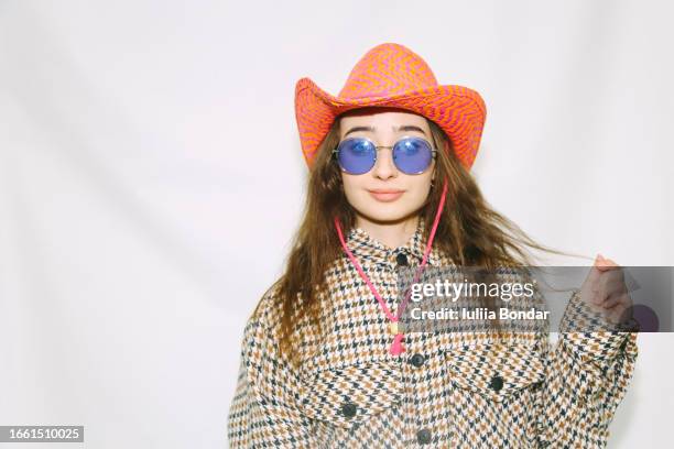 young fashionable woman posing in cowboy hat - retro cowgirl stock pictures, royalty-free photos & images