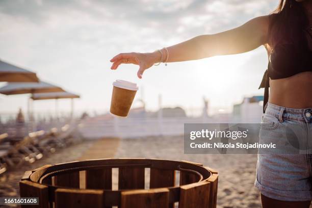 throwing the coffee cup in the bin - throw paper in bin stock pictures, royalty-free photos & images