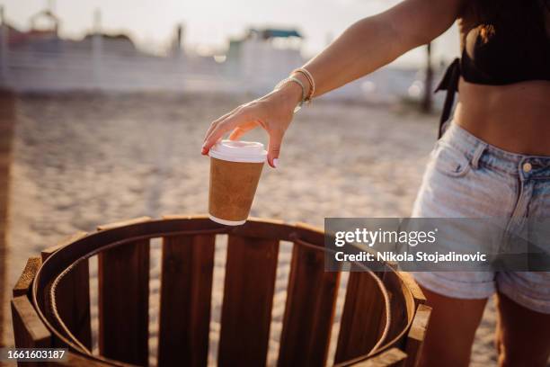 throwing the coffee cup in the bin - throw paper in bin stock pictures, royalty-free photos & images