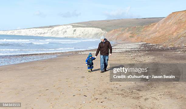 winter beach walk with dad - isle of wight winter stock pictures, royalty-free photos & images