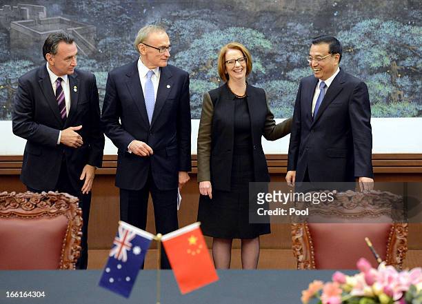 Australian Prime Minister Julia Gillard shares a laugh with Chinese Premier Li Keqiang during a meeting at the Great Hall of the People on April 9,...