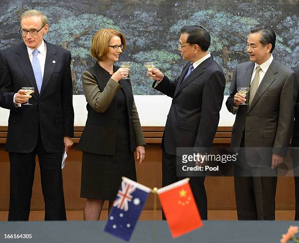Australia prime minister Julia Gillard shares a toast with Chinese Premier Li Keqiang during a meeting at the Great Hall of the People on April 9,...