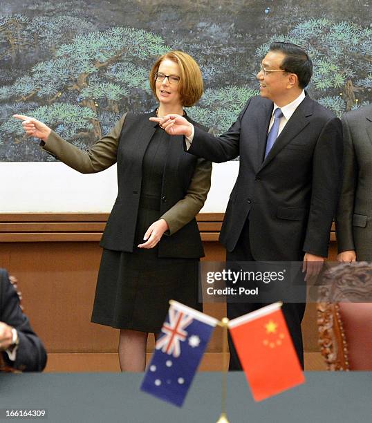 Australian Prime Minister Julia Gillard gestures with Chinese Premier Li Keqiang during a meeting at the Great Hall of the People on April 9, 2013 in...