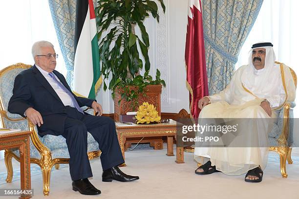 In this handout image provided by the Palestinian Press Office , Palestinian President Mahmoud Abbas attends a meeting with the Emir of Qatar, Sheikh...