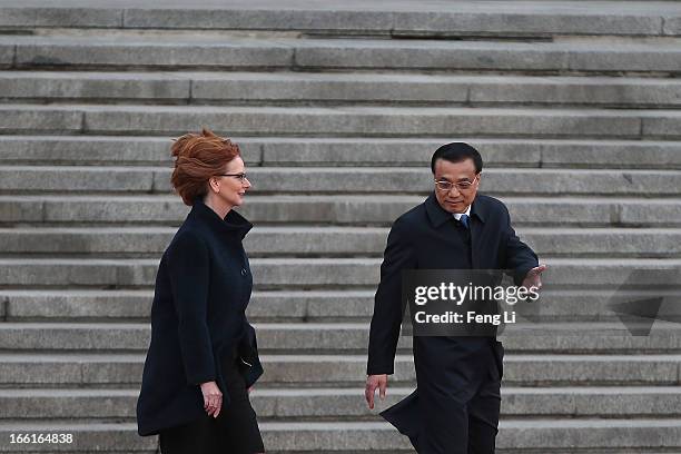 Chinese Premier Li Keqiang accompanies Australian Prime Minister Julia Gillard to view an honour guard during a welcoming ceremony outside the Great...