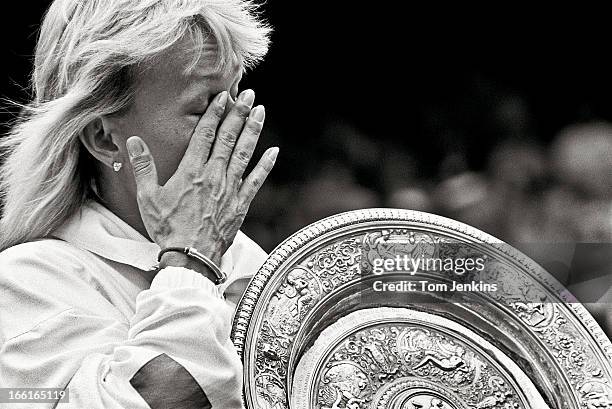 Martina Navratilova of the United States wipes a tear away as she parades around Centre Court with the women's singles trophy after beating Zina...