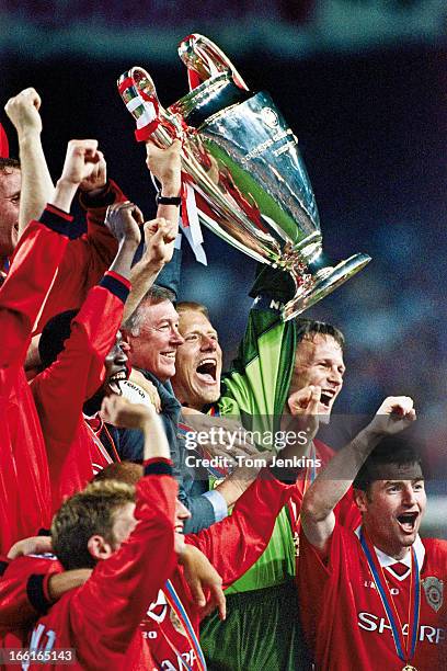 The Champions League trophy is raised aloft by Manchester United manager Sir Alex Ferguson and goalkeeper Peter Schmeichel after their victory over...