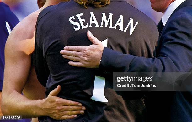 England goalkeeper David Seaman gets consoling hands placed on his back from his captain David Seaman and head coach Sven Goran Eriksson after their...