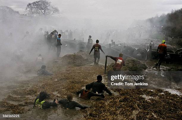 Competitors in the 2007 winter Tough Guy endurance event make their way through mud, smoke and freezing water at South Perton Farm on January 28th...