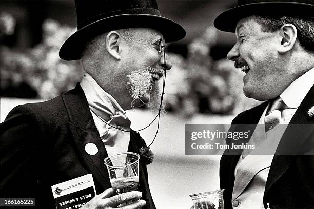 Two spectators share a joke during The Derby race meeting at Epsom racecourse on June 6th 1990 in Epsom, Surrey . An image from the book "In The...