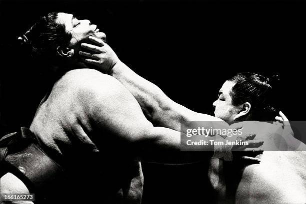 Konishiki , the heaviest sumo wrestler ever, nicknamed the "Dump Truck" gets grabbed round the neck during the opening night of the Grand Sumo...