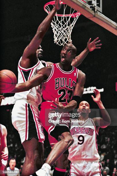 Michael Jordan of the Chicago Bulls basketball team makes a basket from an unusual angle during the match Philadelphia 76ers v Chicago Bulls at the...