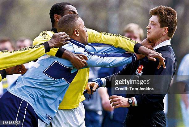 Referee is attacked during an amateur football match at Hackney Marshes on April 25th 2004 in Hackney, London . An image from the book "In The...
