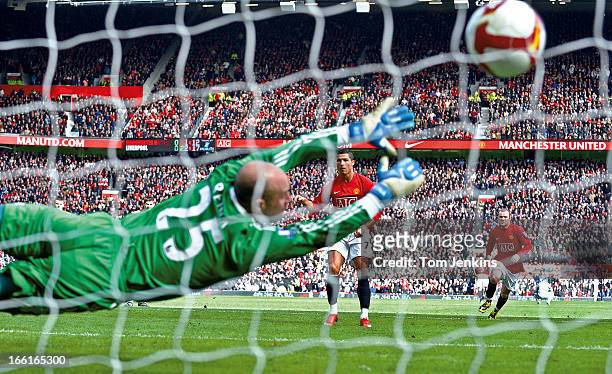 Cristiano Ronaldo of Manchester United scores a penalty past Pepe Reina of Liverpool during the Manchester United v Liverpool Premier League match at...