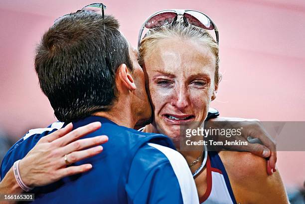 Paula Radcliffe of Great Britain cries on the shoulder of her husband Gary Lough after she could only finish 23rd in the Olympic women's marathon on...