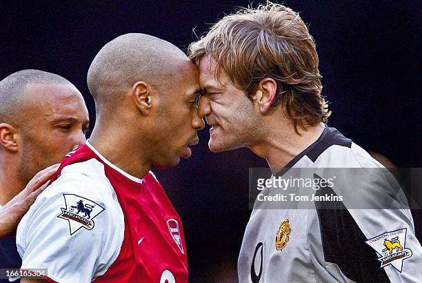 Thierry Henry of Arsenal is angrily confronted by Roy Carroll, the Manchester United goalkeeper during the Arsenal versus Manchester United Premier...