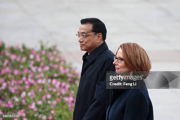Chinese Premier Li Keqiang accompanies Australian Prime Minister Julia Gillard to view an honour guard during a welcoming ceremony outside the Great...