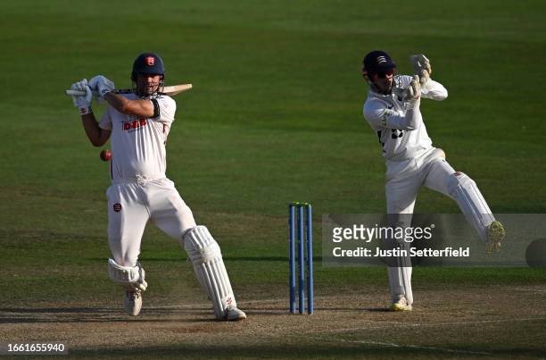 Alastair Cook of Essex plays a shot as Wicket Keeper, John Simpson of Middlesex looks on during the LV= Insurance County Championship match between...