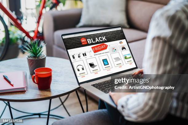 young woman shopping from home at black friday discount. - black friday shopping stockfoto's en -beelden