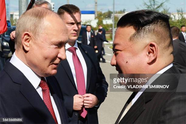 In this pool photo distributed by Sputnik agency, Russia's President Vladimir Putin shakes hands with North Korea's leader Kim Jong Un during their...