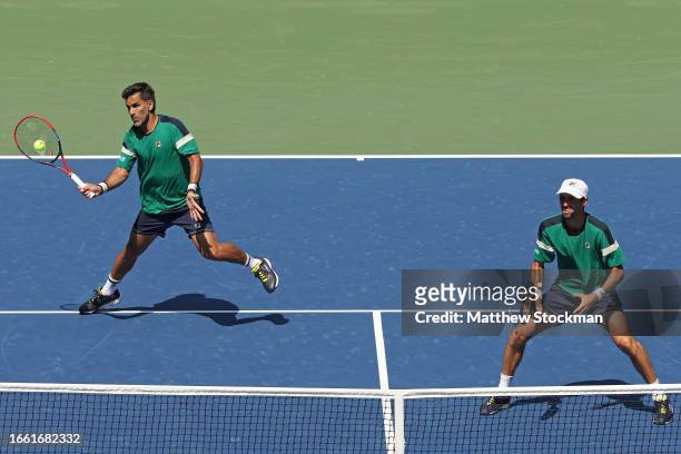 Maximo Gonzalez and Andres Molteni of Argentina return a shot against Rajeev Ram of the United States and Joe Salisbury of Great Britain during their...