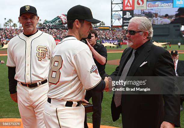 Buster Posey of the San Francisco Giants receives his 2012 Championship Ring from general manager Brian Sabean of the San Francisco Giants during the...