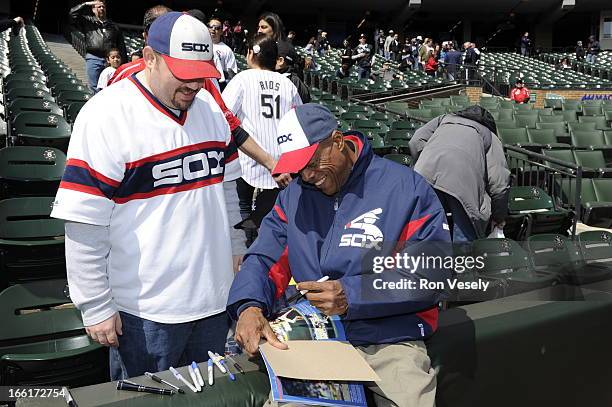 Former MLB and Chicago White Sox player Rudy Law signs an autograph for a young fan prior to the game against the Seattle Mariners on Sunday, April...