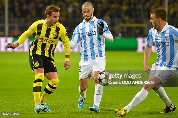 Dortmund's midfielder Mario Goetze , Malaga's midfielder Isco and Malaga's midfielder Ignacio Camacho vie for the ball during the UEFA Champions...