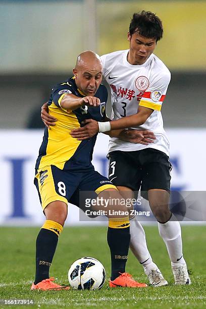 Adriano Pellegrino of the Mariners challenges Zhang Chenglin of Guizhou Renhe during the AFC Champions League match between Guizhou Renhe and Central...