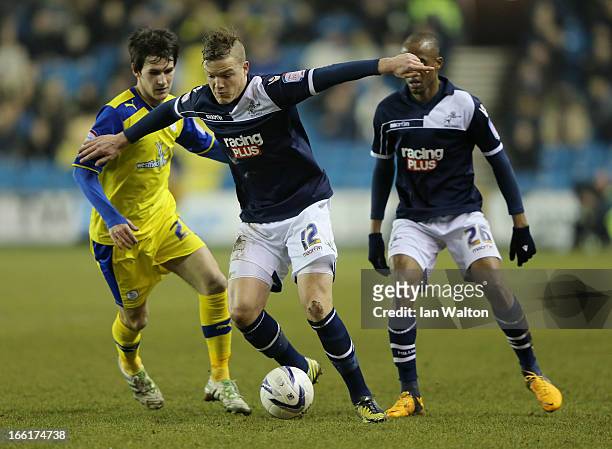 Shane Lowry of Millwall is tackled by Kieran Lee of Sheffield Wednesday during the npower Championship match between Millwall and Sheffield Wednesday...