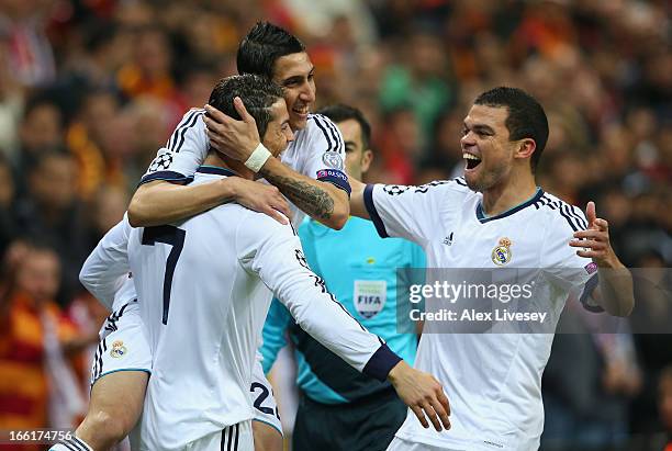 Cristiano Ronaldo of Real Madrid celebrates scoring the opening goal with Pepe and Angel Di Maria during the UEFA Champions League Quarter Final...