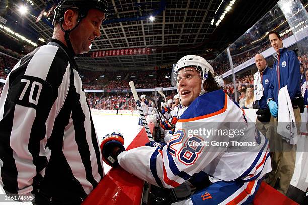 Ryan Jones of the Edmonton Oilers chats with a referee during a stoppage in play against the Calgary Flames on April 3, 2013 at the Scotiabank...