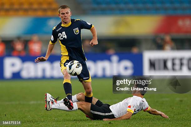 Hayden Morton of the Mariners challenges Rao Weihui of Guizhou Renhe during the AFC Champions League match between Guizhou Renhe and Central Coast...