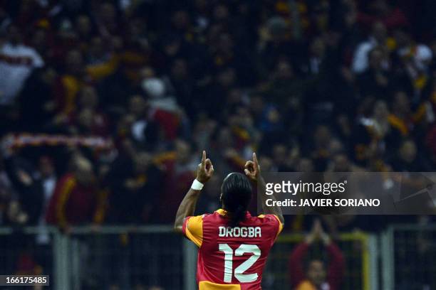 Galatasaray's Ivorian forward Didier Drogba celebrates after scoring their third goal of his team goal during the UEFA Champions League quarter-final...