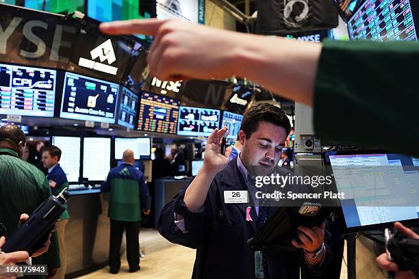 Traders work on the floor of the New York Stock Exchange on April 9, 2013 in New York City. The Dow Jones Industrial Average hit a new record trading...