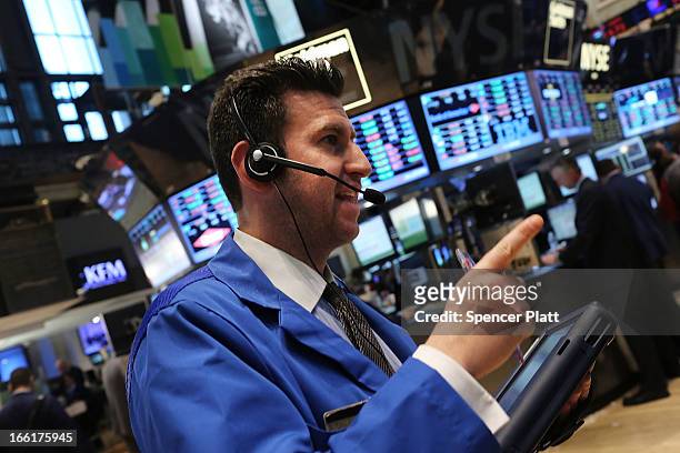Traders work on the floor of the New York Stock Exchange on April 9, 2013 in New York City. The Dow Jones Industrial Average hit a new record trading...