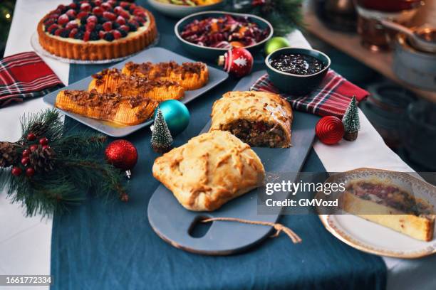 christmas dinner with vegan mushroom beef wellington, butternut squash, green beans and berry pie - christmas mince pies stock pictures, royalty-free photos & images