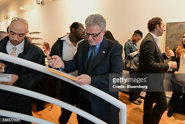 Job seeker Vincent Mazzone center, fills out a job application during the NYC Restaurant Job Expo at the Gabarron Foundation in New York, U.S., on...