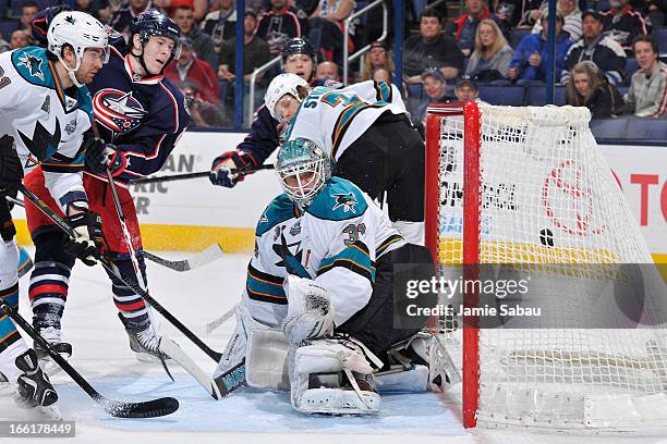 Goaltender Antti Niemi of the San Jose Sharks watches as a shot taken Matt Calvert of the Columbus Blue Jackets goes into the net during the first...