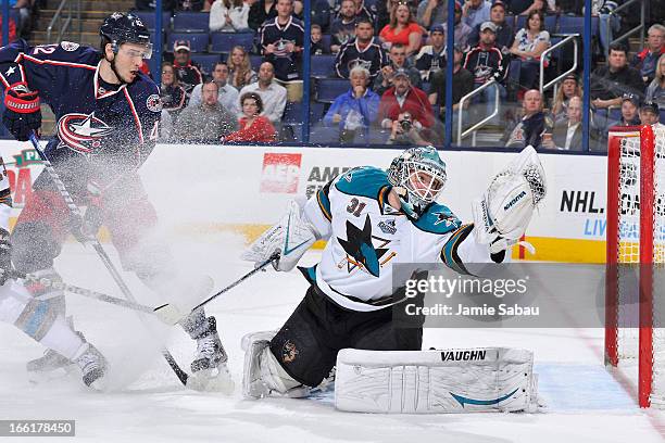 Goaltender Antti Niemi of the San Jose Sharks makes a glove save during the first period on April 9, 2013 at Nationwide Arena in Columbus, Ohio.