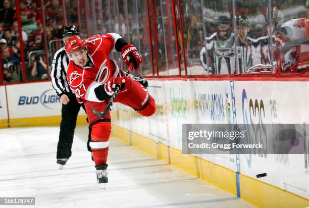 Justin Faulk of the Carolina Hurricanes dumps the puck during an NHL game against the Pittsburgh Penguins during their NHL game at PNC Arena on April...