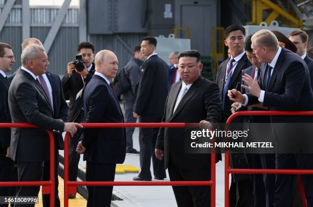 In this pool photo distributed by Sputnik agency, Russia's President Vladimir Putin and North Korea's leader Kim Jong Un visit the Vostochny...