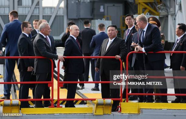 In this pool photo distributed by Sputnik agency, Russia's President Vladimir Putin and North Korea's leader Kim Jong Un visit the Vostochny...