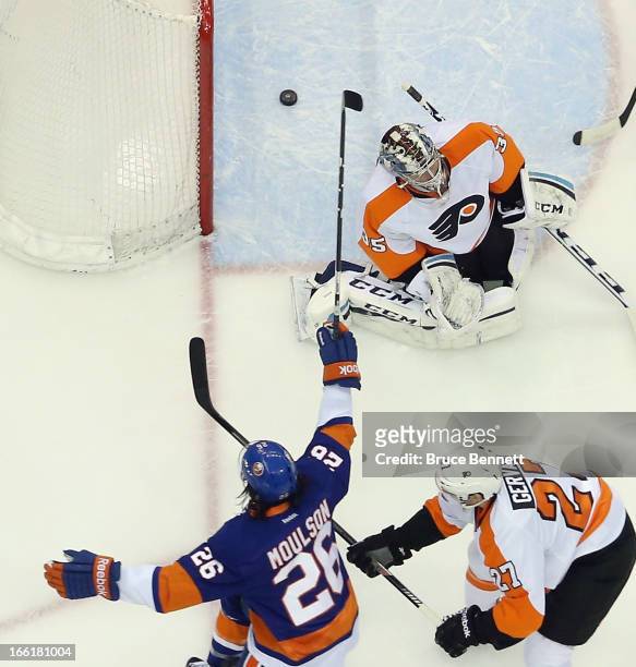 Matt Moulson of the New York Islanders scores at 15:36 of the first period against Steve Mason of the Philadelphia Flyers at the Nassau Veterans...